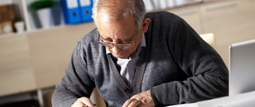 An older person working at a desk