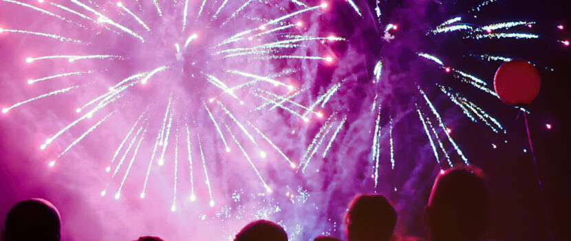 A crowd of people watching a fireworks display