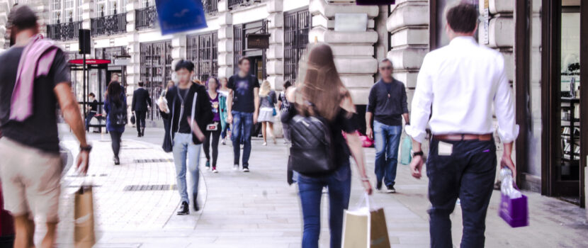 People walking down a busy shopping street in London