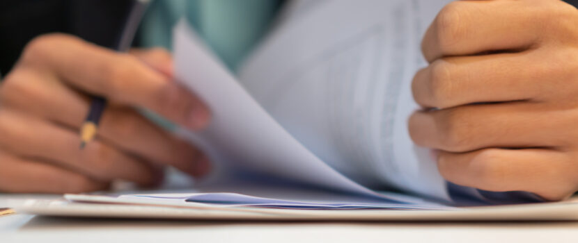 Close up of a man looking through some paperwork