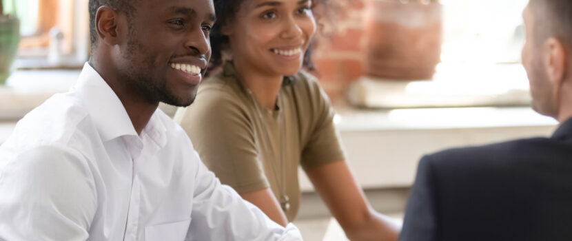 A couple talking to a financial planner.