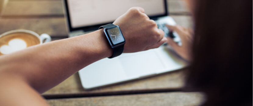 A woman checking the time on a watch.