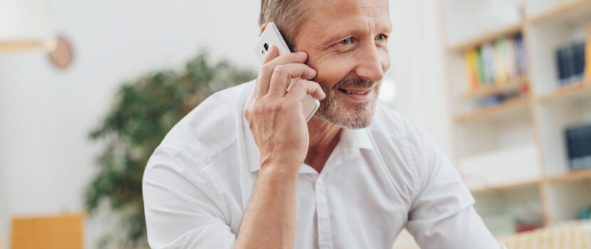 A man taking a phone call at home.