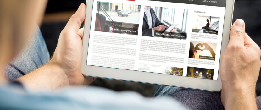 A man reading the news on a tablet.